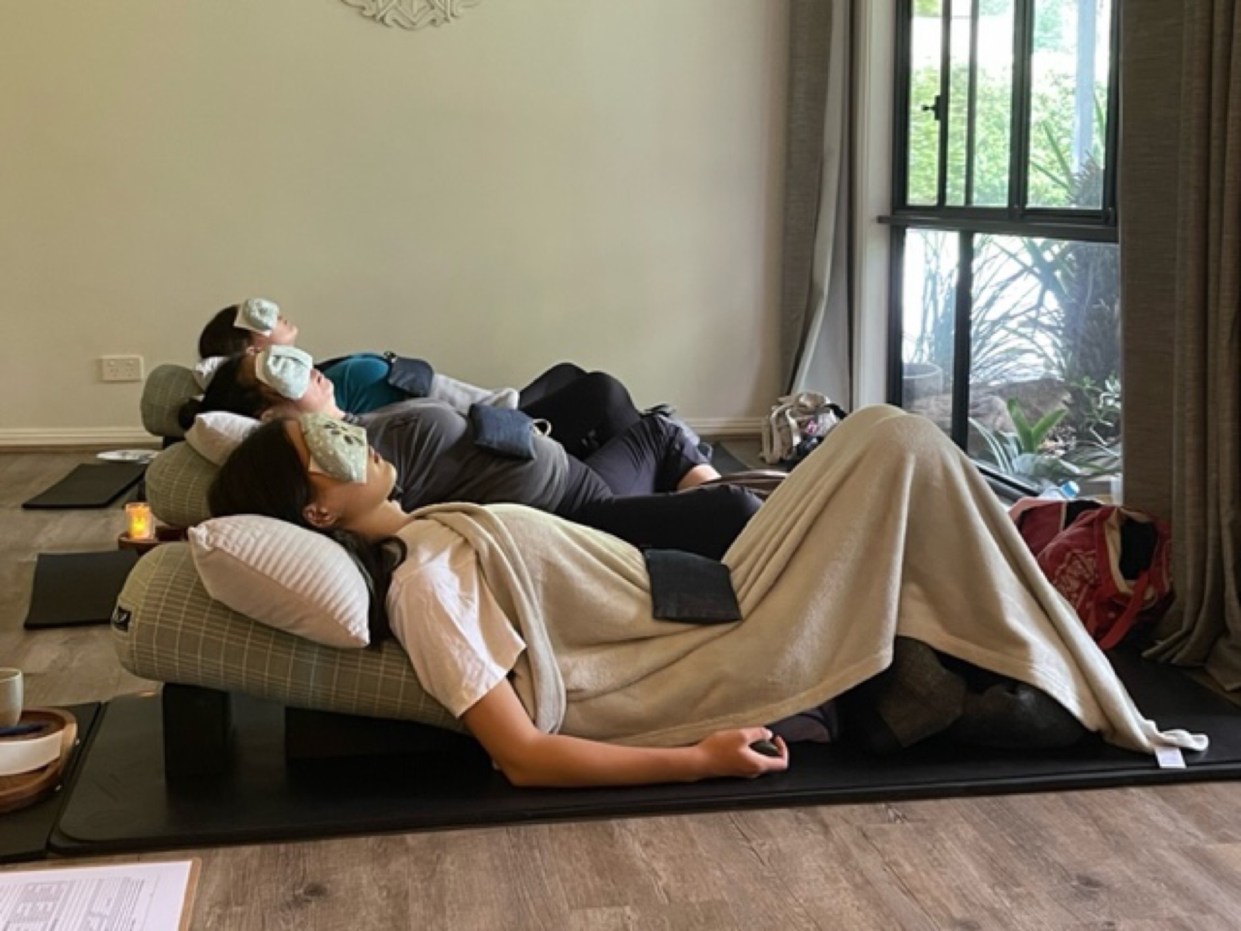 A student resting in a supported restorative pose